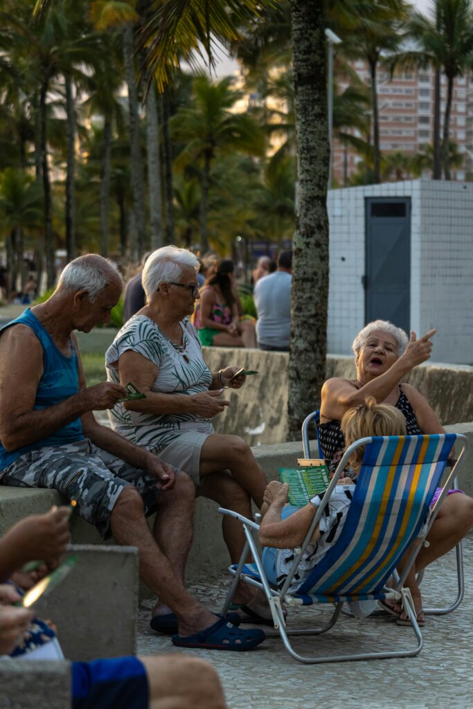 Senior adults sitting outdoors in summer, enjoying the evening in an urban setting.